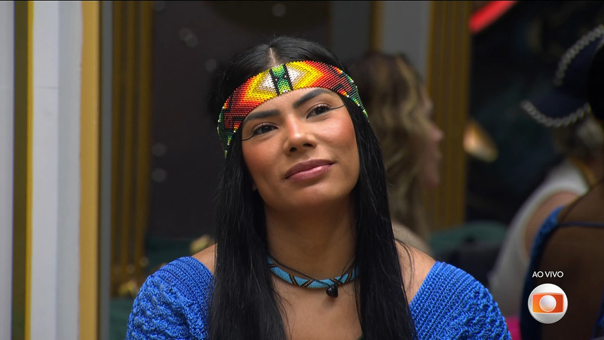 Marciele vestida de azul, sentada no sofá da casa do BBB 26, antes da eliminação do BBB 26