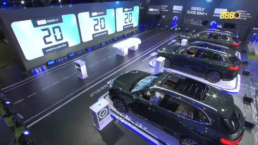 Três carros da geely estacionados no gramado do BB 26 na prova do finalista. Painéis de LED ligados mostram um tempo de execução