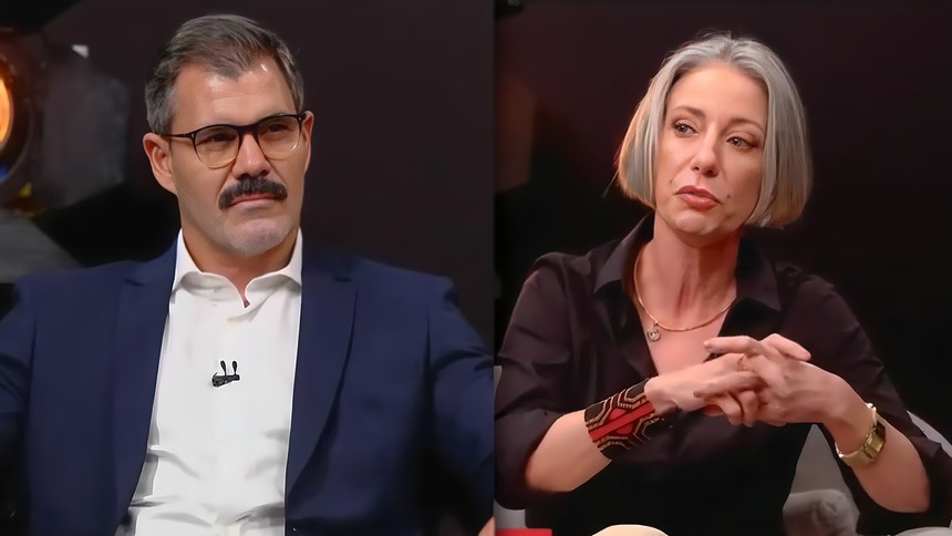 Juliano Cazarré olha sério para Vera Iaconelli. Os dois estão sentados lado a lado no estúdio do GloboNews Debate