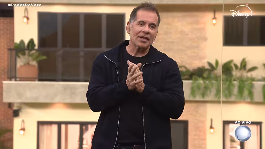 Leandro Hassum vestindo um agasalho preto no glass de estúdio, em trecho da Casa do Patrão