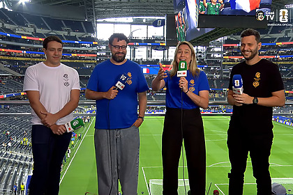 Fernanda Gentil ao lado de outros três apresentadores, em pé na arquibancada do estádio de onde a CazéTV exibiu França x Espanha na Copa do Mundo