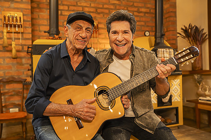 Fagner e Daniel seguram um mesmo violão e sorriem nos bastidores do Viver Sertanejo