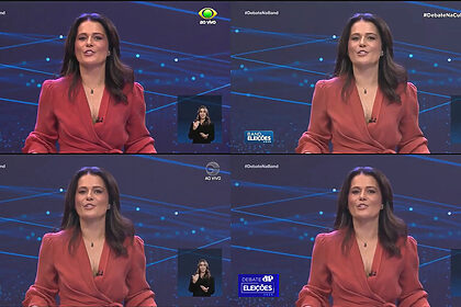 Adriana Araújo em pé apresentando o Debate na Band