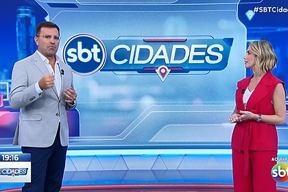 Rodrigo Bocardi e Erica Reis em pé no cenário do SBT Cidades