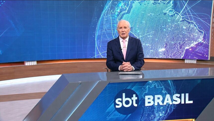 Celso Freitas sentado na bancada do SBT Brasil